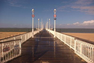 Pier amidst sea against sky