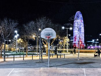 Illuminated street light against sky at night