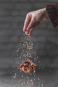 Person holding ice cream in water