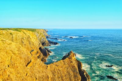 Scenic view of sea against clear blue sky