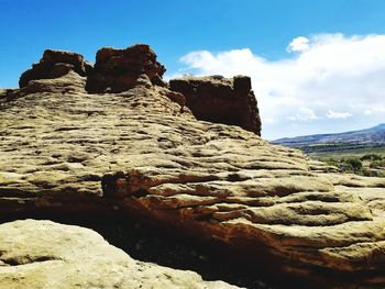 Low angle view of rock formations against sky