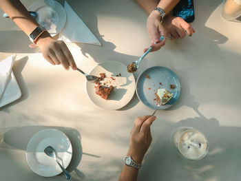 High angle view of woman eating cake on table