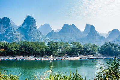 Scenic view of lake and mountains against sky