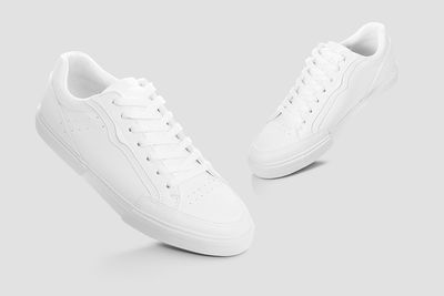Close-up of shoes over white background