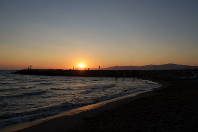 Scenic view of beach against sky during sunset