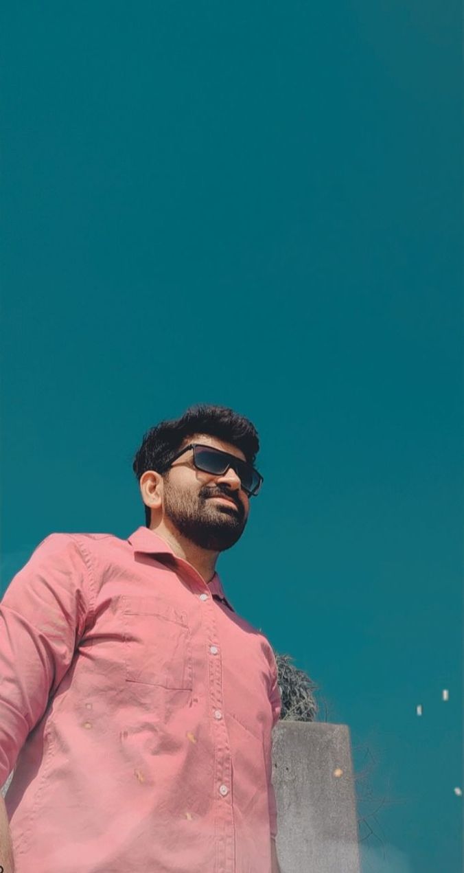 blue, one person, adult, copy space, waist up, men, standing, looking, young adult, portrait, sky, looking away, casual clothing, nature, facial hair, lifestyles, glasses, clothing, leisure activity, beard, smiling, clear sky, emotion, outdoors, front view, fashion, day, person, happiness, low angle view, spring, colored background