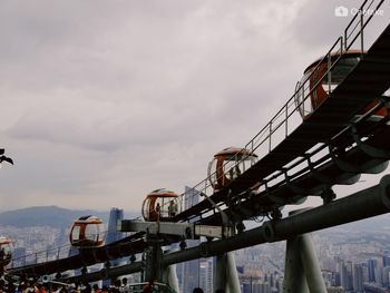 Low angle view of bridge in city against sky