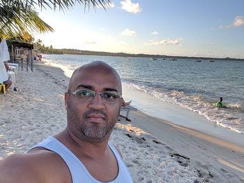 Portrait of man on beach against sky