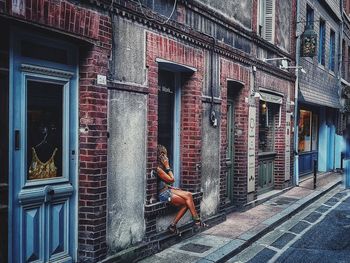 Side view of man on street against building