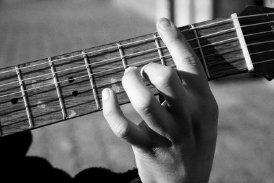 Close-up of hand playing guitar