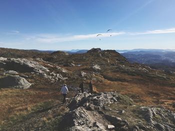 High angle view of friends hiking on mountain against sky