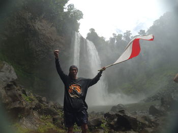 Raising the flag under the waterfall