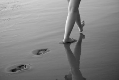 Low section of woman legs in water