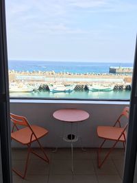 High angle view of chairs at beach against sky