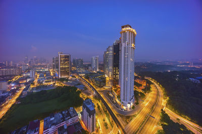 High angle view of illuminated buildings against sky at night