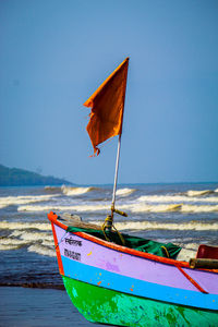 Umbrella on beach against blue sky