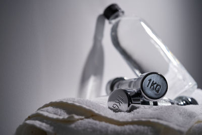 Close-up of faucet on table against wall at home