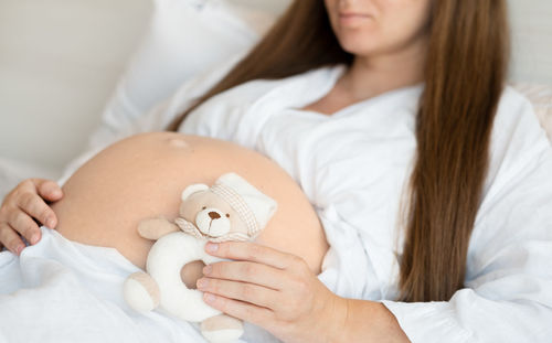 Midsection of woman holding flower bouquet