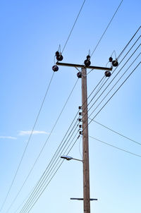 Low angle view of power lines against sky