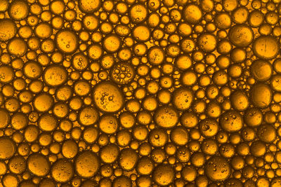 Yellow and orange bubbles, drops of oil in water