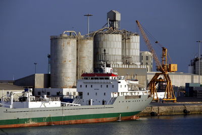 Container ship on sea by factory