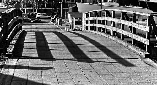 Shadow of man on footbridge in city