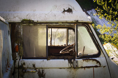 Side view of cropped abandoned vehicle