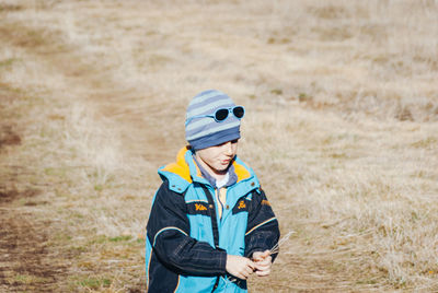 Boy standing on grassy field