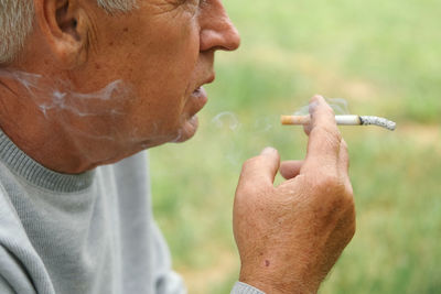 Close-up of man smoking cigarette