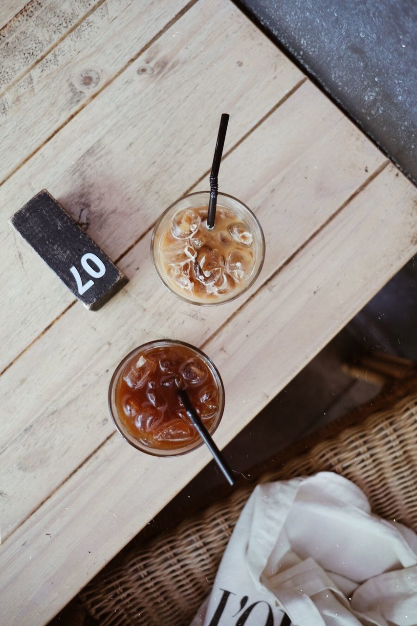 HIGH ANGLE VIEW OF COFFEE ON WOODEN TABLE