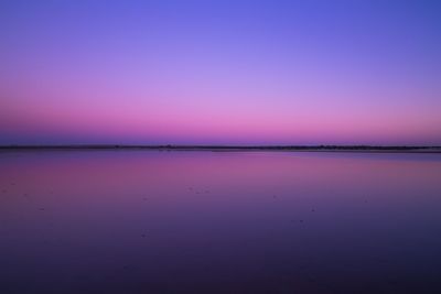 Scenic view of sea against clear sky at sunset