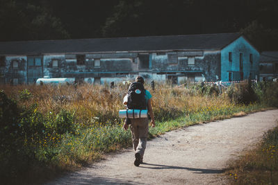 Rear view of woman walking on road