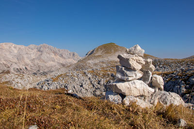 Rocks on mountain against clear blue sky