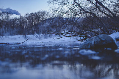 Scenic view of frozen lake against sky during winter