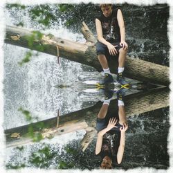 Full length of young woman splashing water