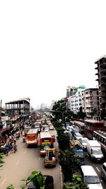 Traffic on city street against clear sky