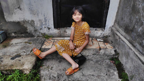 Little girl posing in a backyard with natural background