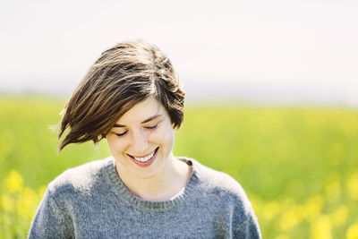 Portrait of smiling young woman on field