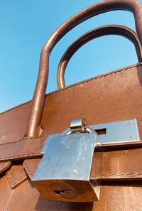 Low angle view of metal structure against clear blue sky