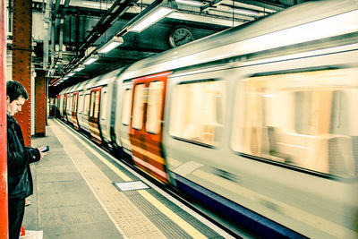 Blurred motion of train at railroad station