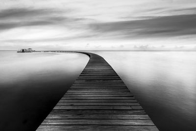 Pier over sea against sky