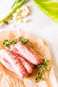 Directly above shot of sausages and vegetables on table