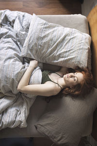 High angle view of woman sleeping on bed at home