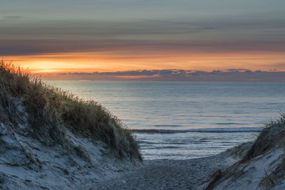 Scenic view of sea against sky at sunset