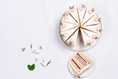 High angle view of cake on table against white background