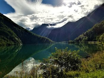 Scenic view of lake and mountains against sky