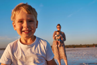 Happy woman and son on the sea shore. harmony in family