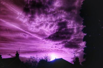 Silhouette of built structure against cloudy sky