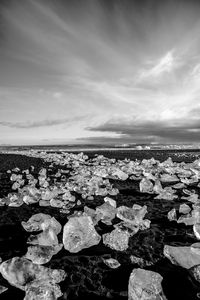 Rocks by sea against sky