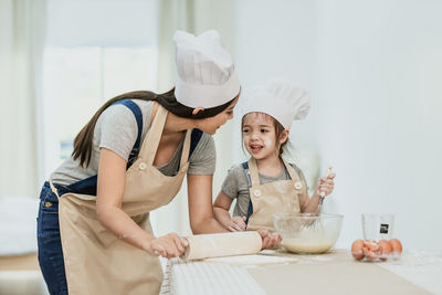 Rear view of mother and daughter in bowl